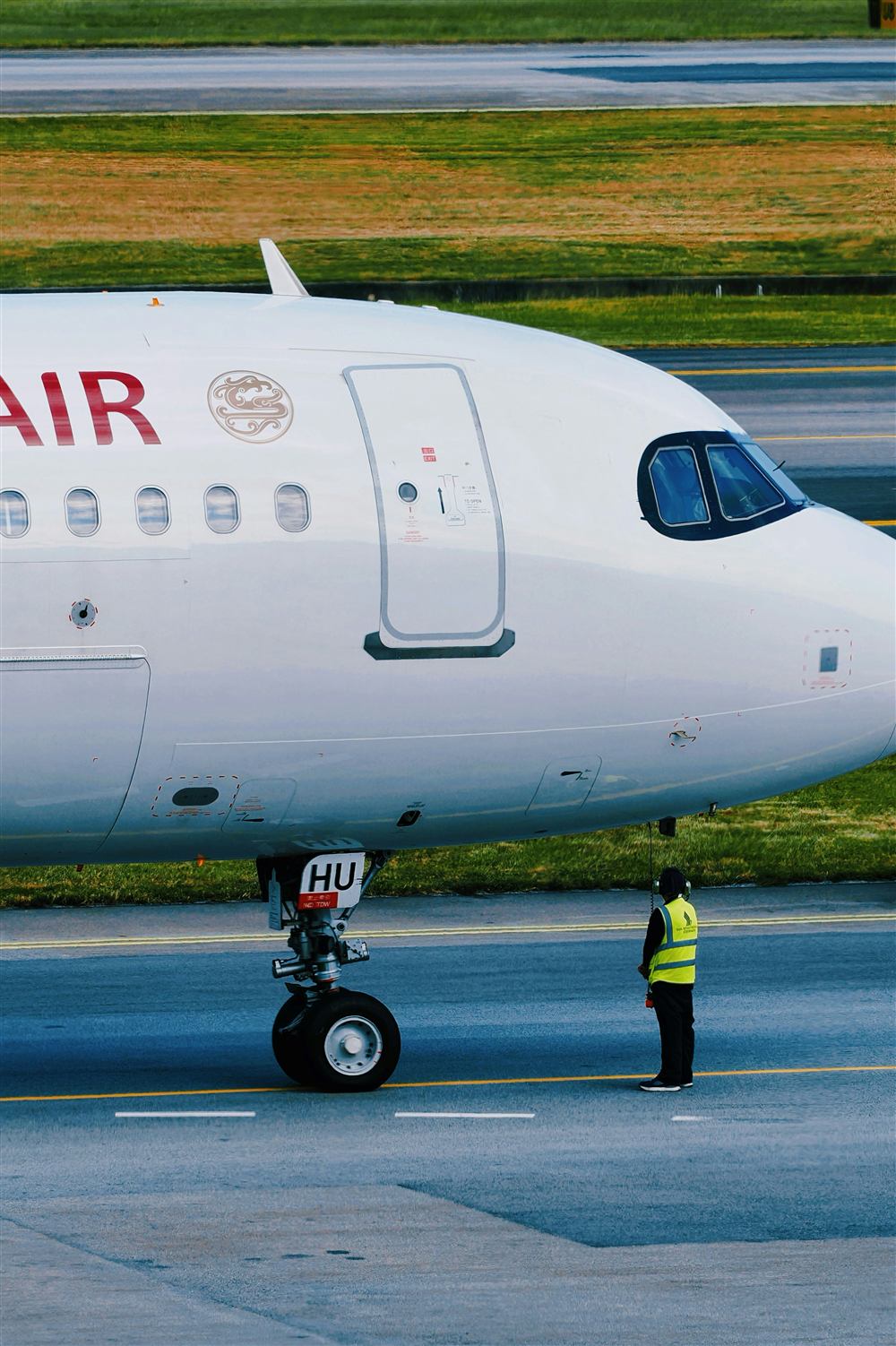 Ground crew coordinating near an aircraft on an airport ramp.