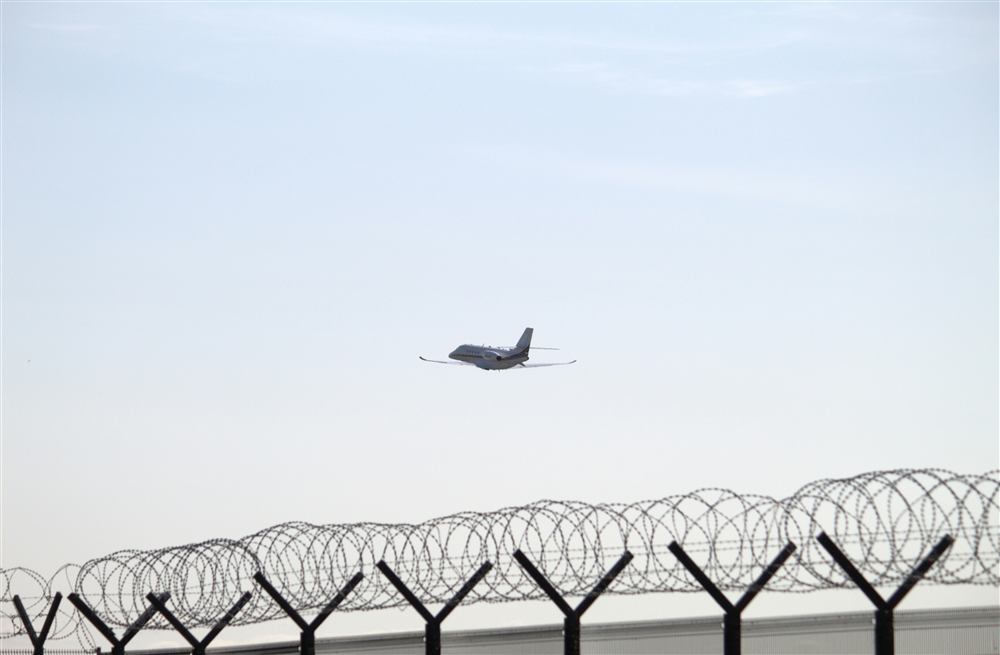 Airport perimeter fencing marking a controlled, secure airside area.