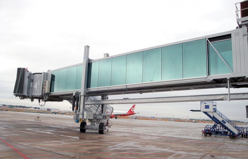 Passenger boarding bridge connected to an aircraft gate.